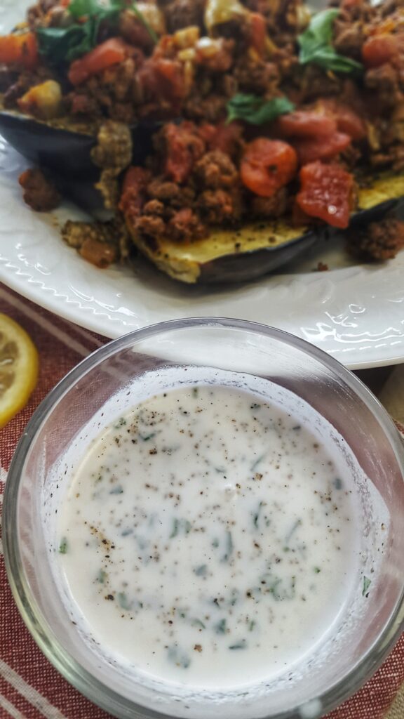 A simple dairy-free lemon herb sauce is made by mixing coconut milk with fresh herbs, lemon juice and salt and pepper. It goes great with the Mediterranean Lamb Stuffed Eggplant!