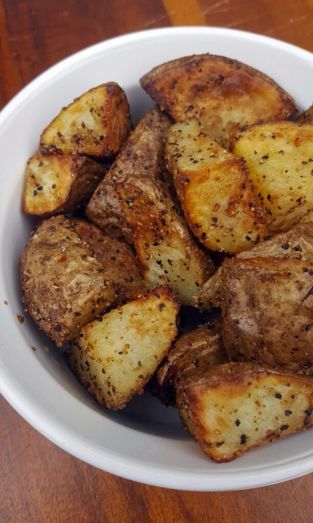 Tossed with EVOO and Montreal steak seasoning and then roasted to crispy perfection in an air fryer, these Whole30 "roasted"potatoes are a meal prep must-have!