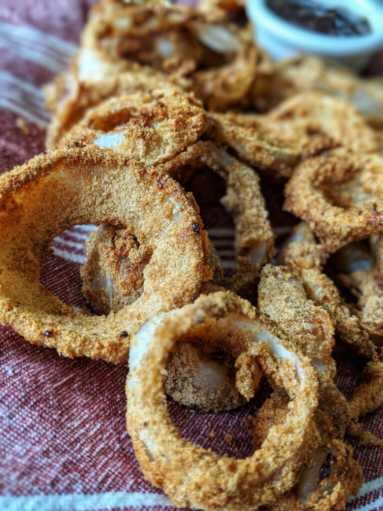 The secret to perfectly air fried onion rings is soaking them in coconut milk before dredging them in gluten-free panko and then air frying them in a single-layer in a 400 degree air fryer. Perfect homemade onion rings everytime!
