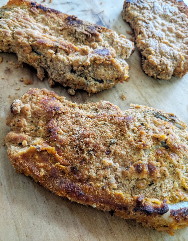 These Whole30, Paleo & Keto friendly pork chops are brined in pickle juice before being dredged in a coconut flour breading and baked in the oven.
