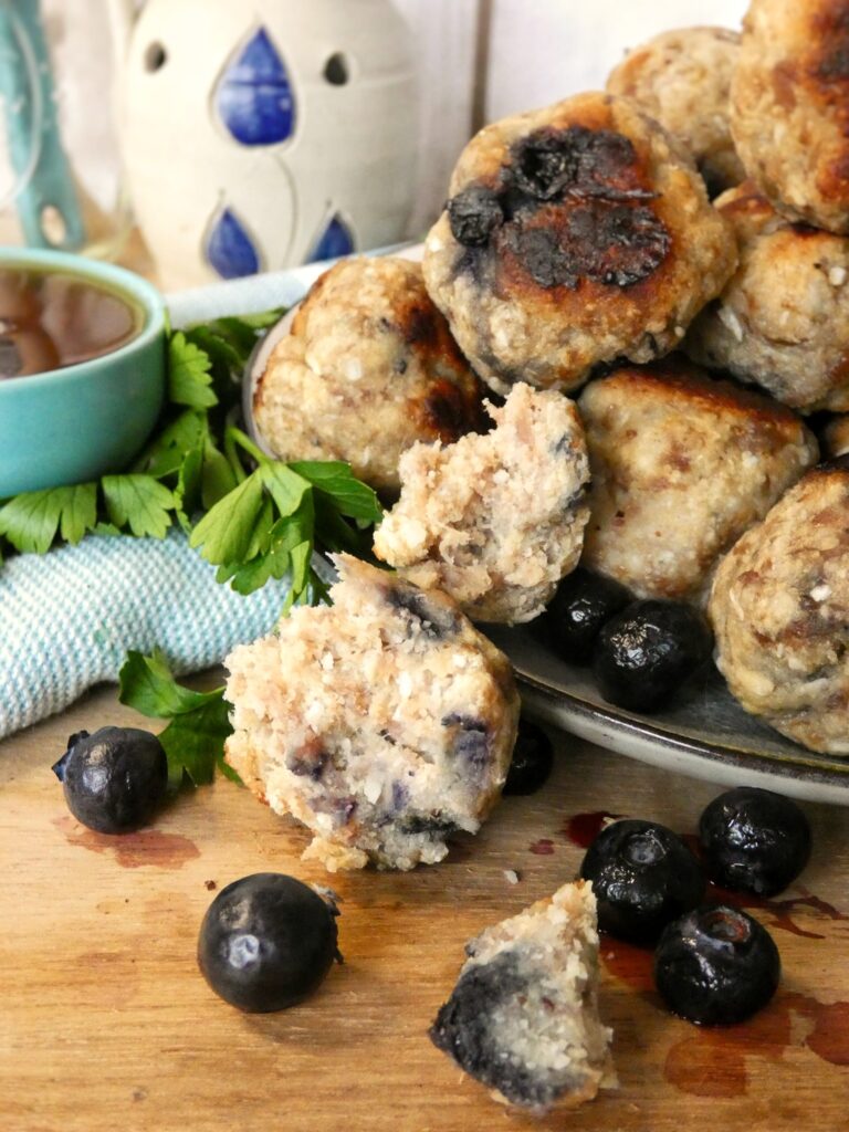 Grain-free pancake mix, savory breakfast sausage and blueberries gets formed into meatballs and baked in the oven. They make a great on-the-go flavor packed Paleo breakfast!