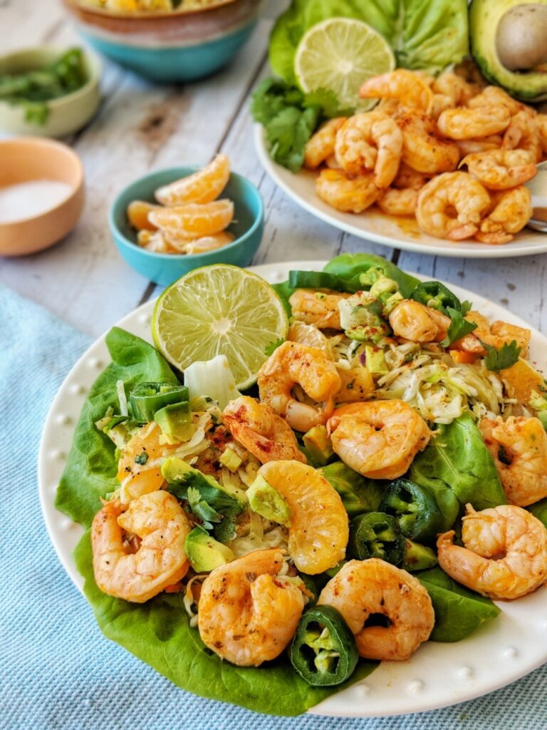 Citrus blackened marinated shrimp are piled high above a bed of coleslaw and finished with diced avocado, jalapenos and fresh cilantro.