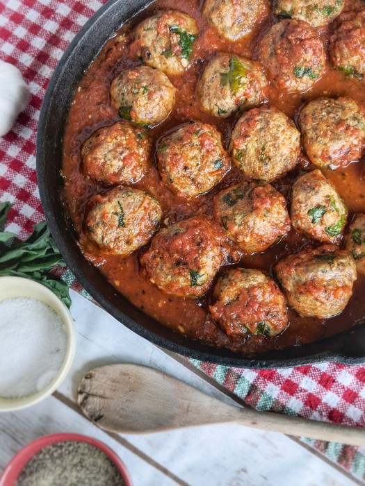 Baked Italian Meatballs are simmered in a homemade vibrant red marinara sauce. 