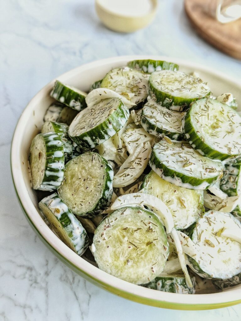 Sliced English cucumbers and slivered Vidalia onions are dressed in a tangy dairy-free creamy Gurkensalat style dressing.