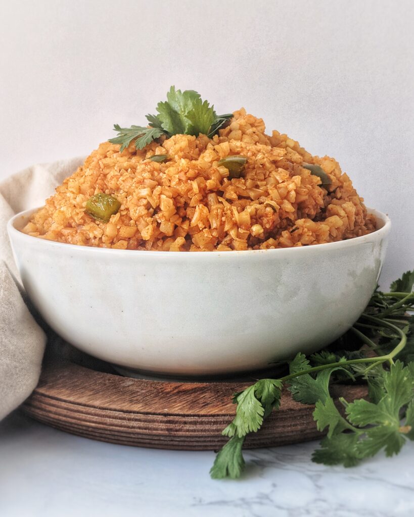 Frozen bags of riced cauliflower are used to make delicious and flavorful Mexican rice in an pressure cooker or on the stove top.