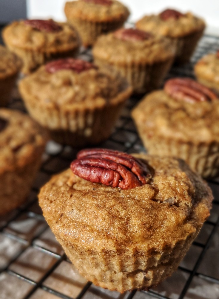 Perfectly sweetened grain-free muffins are presented on a wire cooling rack.